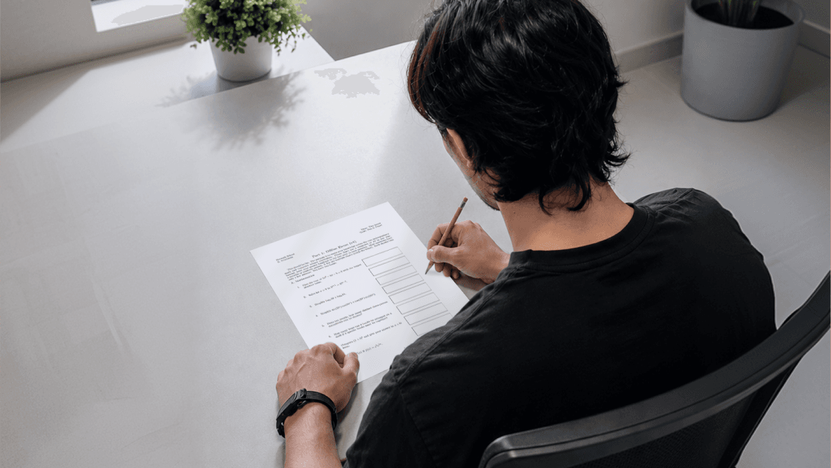 A person taking a paper exam at Network School